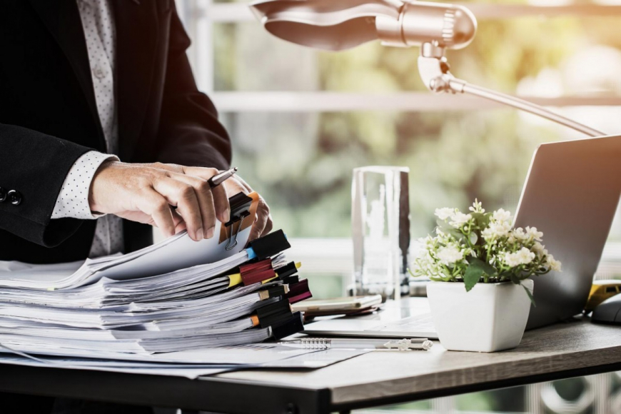 Person going through stack of files