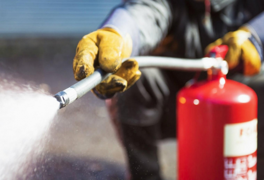 Person using fire extinguisher