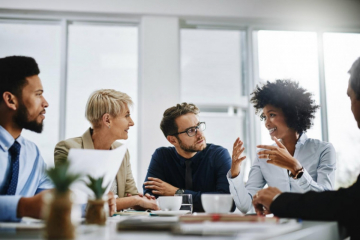 Four coworkers meeting around a table 