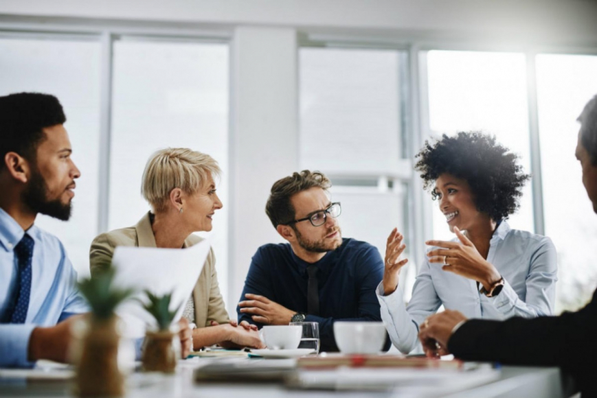 Four coworkers meeting around a table 