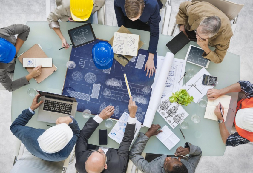 People discussing blueprints 
