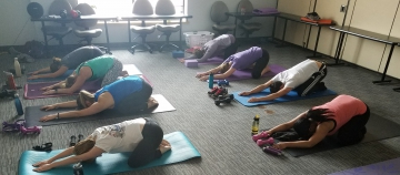 Employees doing yoga at the office