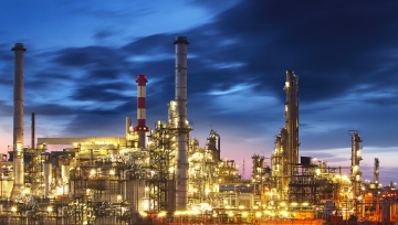 oil rig stacks and lights at night