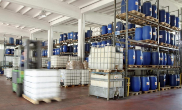 Warehouse shelves with blue barrels