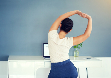 Woman Stretching at a Desk