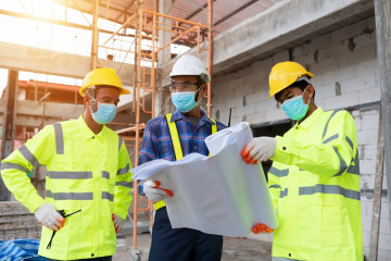 Employees Looking Over Plans