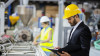 Man in Suit Wearing a Hardhat in warehouse