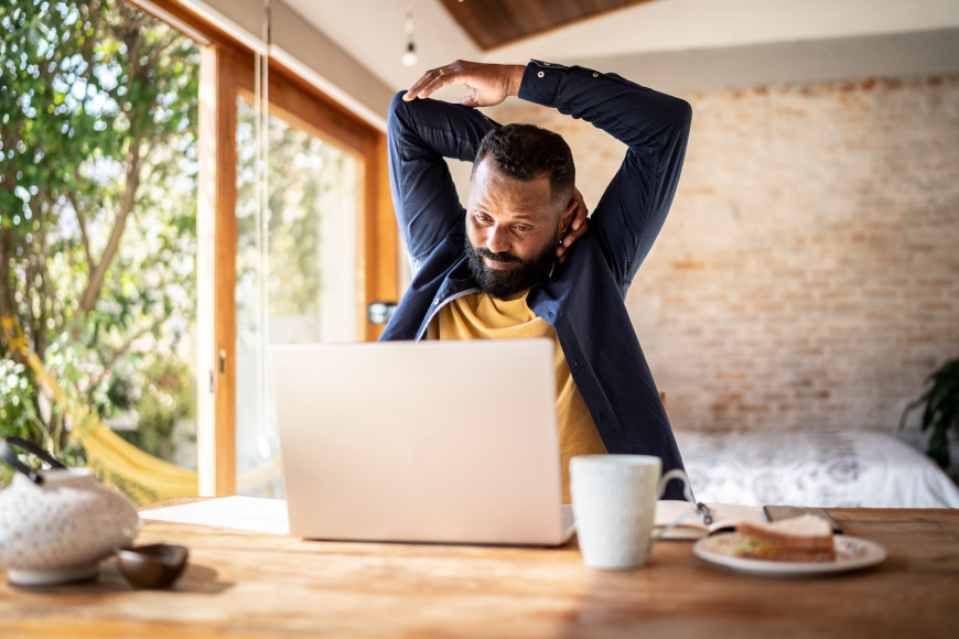 Male Employee Stretching at His Desk
