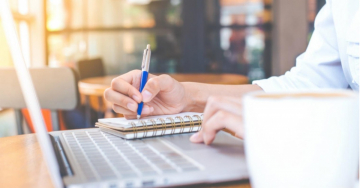 Person writing in notebook