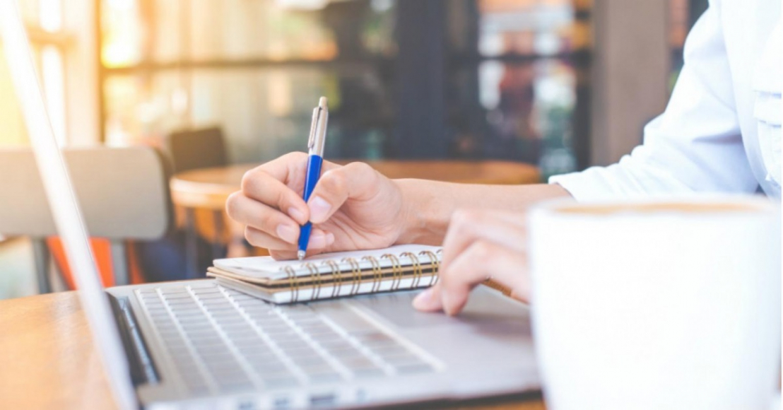Person writing in notebook