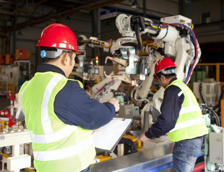 People working on robotic machine