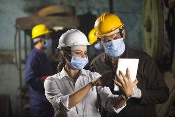 Employees wearing face masks and hard hats