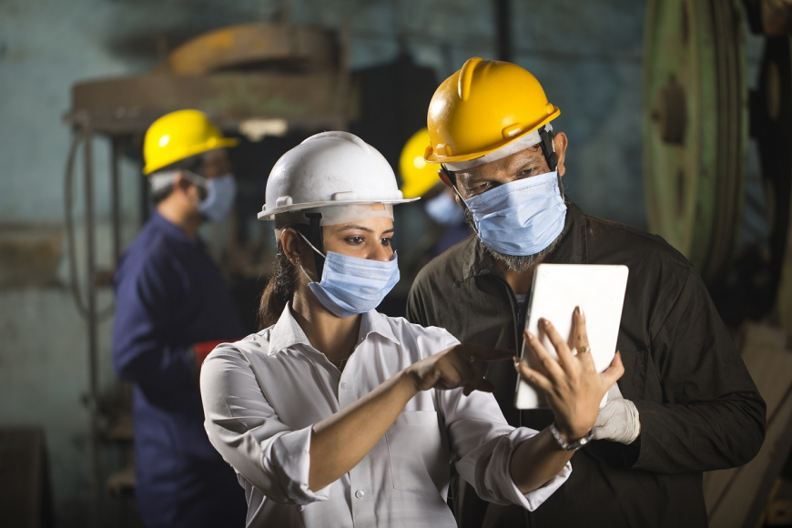 Employees wearing face masks and hard hats
